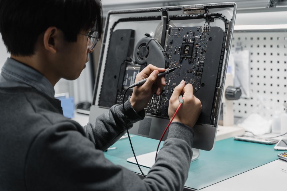Technician testing the internal components of a desktop computer